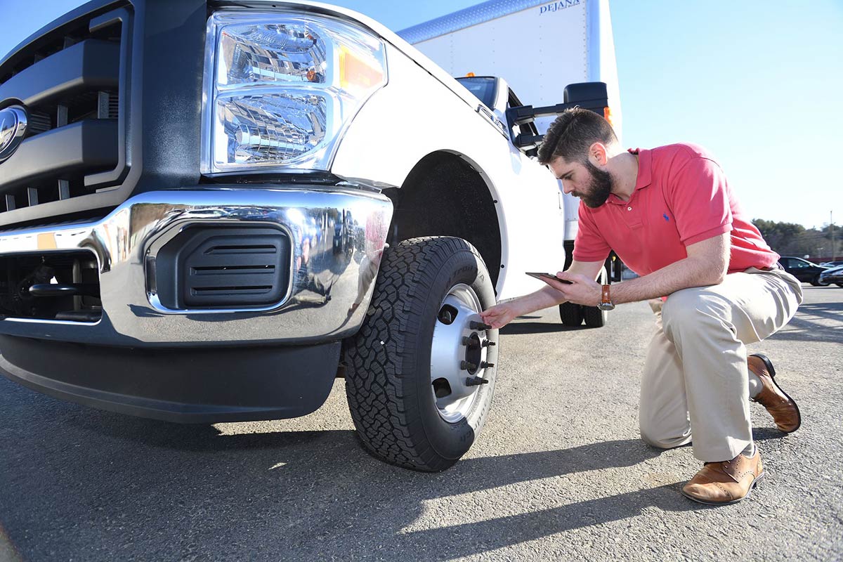 inspecting-truck-tire